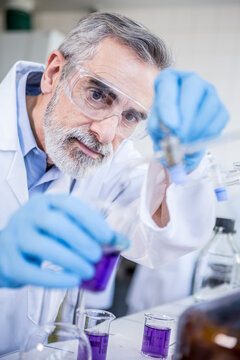 Scientist in lab working with liquid