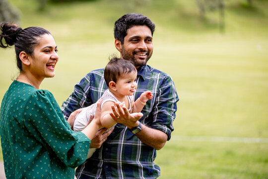 Happy Indian family together in a public park outdoors