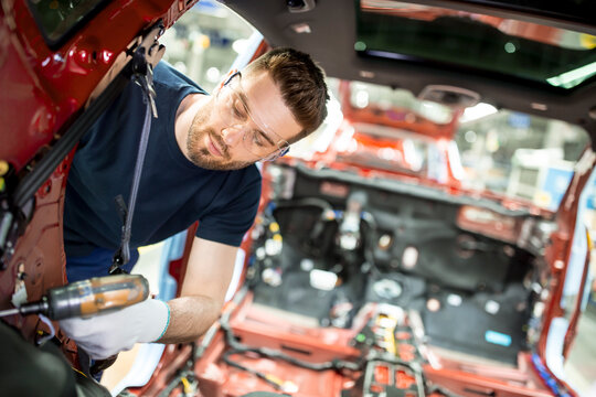 Man working at bodywork in modern car factory