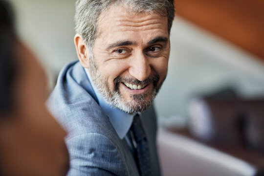 Portrait of a smiling businessman looking at colleague