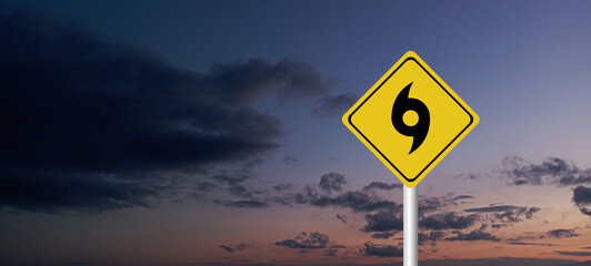Hurricane Idalia warning sign against a powerful stormy background with copy space. Dirty and angled sign with cyclonic winds add to the drama.hurricane season sign on cloudy background