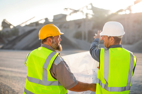 Quarry workers checking site plan