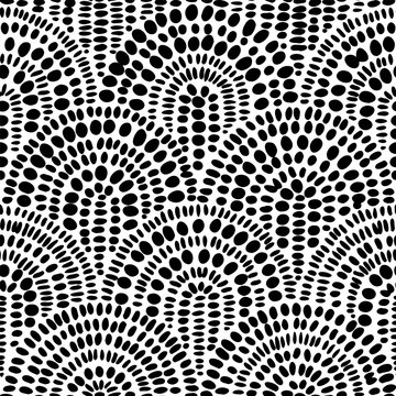 Seamless monochrome geometric pattern. Hand drawn oval dots forming radial arches. Bold black and white contrast design. Vector illustration for modern surface and print.