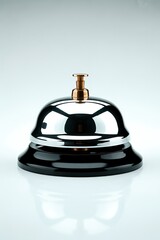 Shiny black and gold service bell on white background
