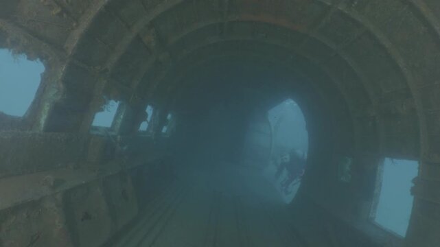 log footage of scuba divers are exploring a c47 dakota airplane wreck underwater 
