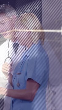 Vertical video: Dr and nurse reviewing results, nurse tapping tablet causing medical data rise