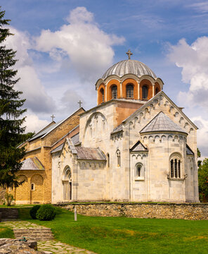 Deserted meadows around building of Church of Annunciation of Blessed Virgin Mary, monastery compound in city of Gradac, located on hill among mountains, Serbia.