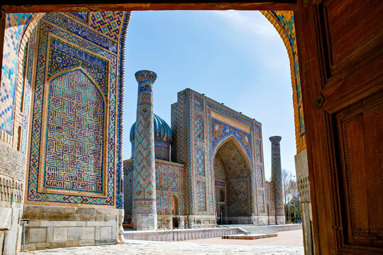 Part of Registan Square in Samarkand, Uzbekistan, a historic architectural ensemble featuring three stunning madrasas. In old arabic God is great on the walls