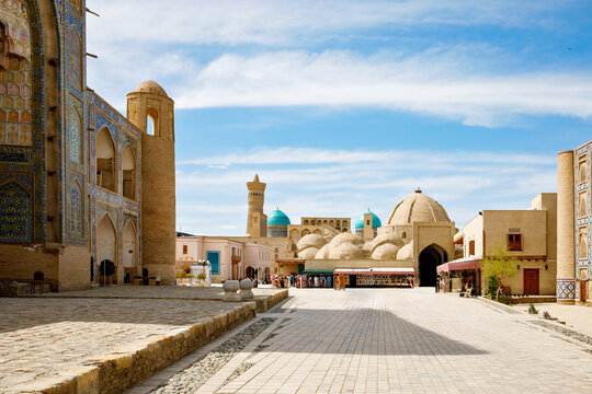 Kosh Madrasah complex in Bukhara with Ulugh Beg and Abdulaziz Khan Madrasas framing Toki Zargaron domes, historic Islamic architecture