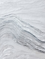 Obraz premium Grey Abstract Texture with Wavy Lines and Grainy Pattern Creating an Icy Winter Surface for Digital Wallpaper and Cover Design Background with Copy Space
