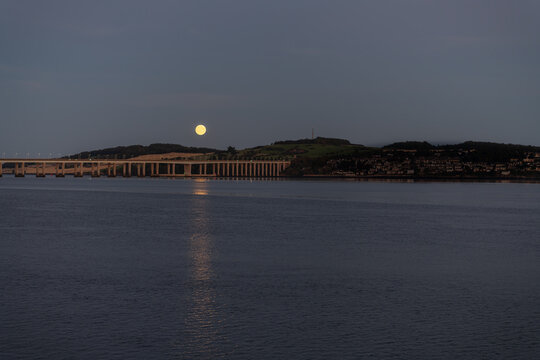Moon rise over the Tay Road bridge reflected in the River Tay, Dundee, Angus, Scotland