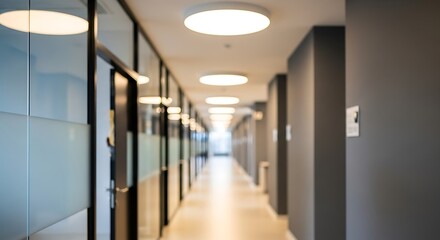 Blurred perspective of a modern hallway with glass walls and circular ceiling lights