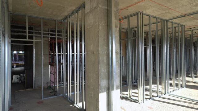 Interior walls set-up on construction site. Metal studs create drywall frame.