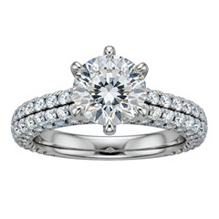 Ornate diamond engagement ring featuring a large brilliant-cut center stone, intricate luxury setting, highly polished metal band