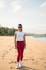 Fit Asian Woman in Sportswear Standing on Beach During Summer Workout