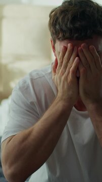 Angry Caucasian man receiving bad news on smartphone feeling frustrated male throwing mobile phone at home bedroom guy upset by notification bankruptcy divorce irritation stress problem crisis indoors