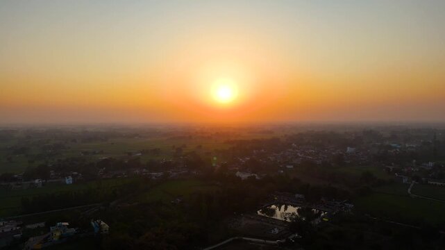 Aerial drone shot of sunset or sunrise with foggy ground and trees 