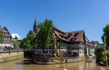 Fototapeta premium Picturesque View of Esslingen am Neckar Old Town with Historic Half Timbered Houses and River Waterfront under Blue Sky