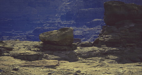 twilight rocky shoreline with deep blue sky, wet boulders and tidepools, textured granite surfaces, lowlight reflections, serene moody atmosphere and distant © icetray