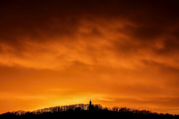 Fototapeta premium Cathedral Silhouette at Summer Sunset with Red and Orange Sky