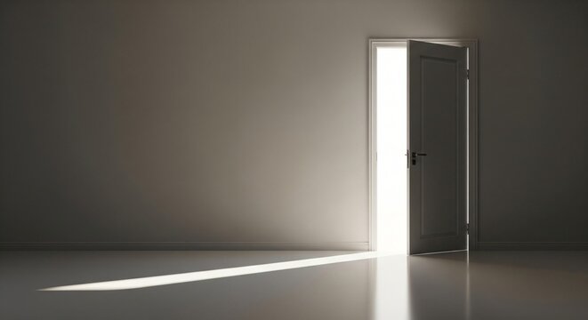 Open doorway casting a bright light beam across a dark room floor and wall
