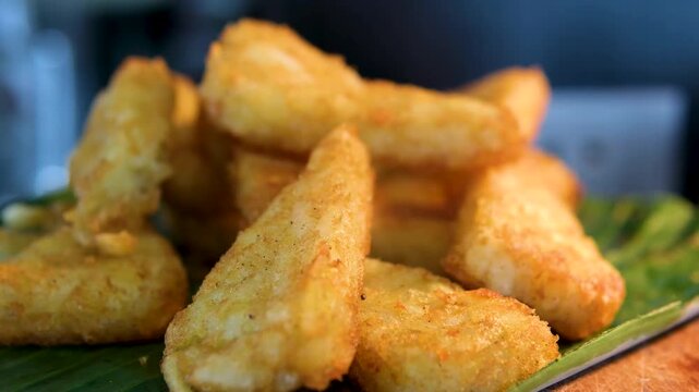 fish meat nuggets in batter fried Fried platanos on plate. Sliced and cooked tostones. Rotating. Vertical footage