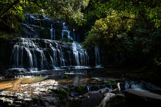 3 Tiered waterfall shadowed in a rainforest