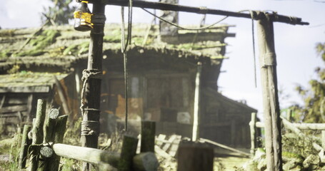 A rustic wooden house stands in a serene setting, featuring a hanging lantern and overgrown vegetation. Sunlight filters through the trees, adding warmth to the scene.