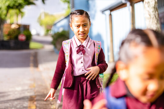 Samoan schoolchildren walking on the roadside going to school
