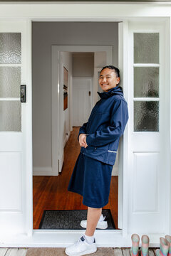 Teenage Samoan girl leaning against the door frame