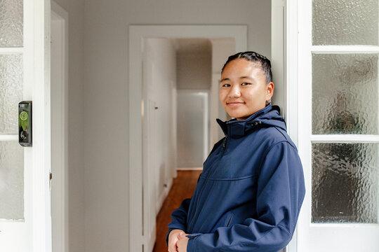 Teenage Samoan girl leaning against the door frame