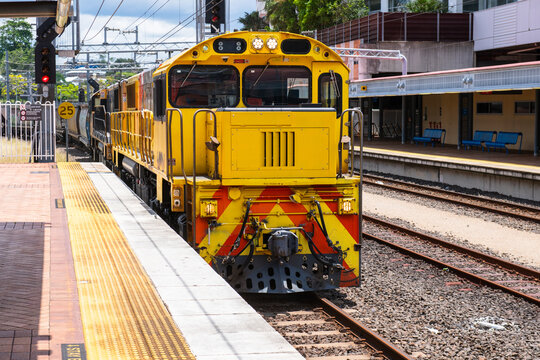 freight train coming through a station