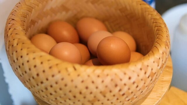 wicker basket adds eggs in the basket. Brown chicken eggs in hay and wicker basket. Preparing for Easter. Eco products, organic farming products.