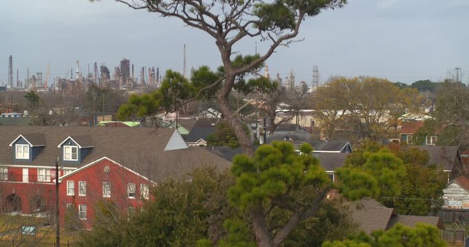 Ascending drone shot from neighborhood revealing Baytown Homes and Nearby Chemical Infrastructure