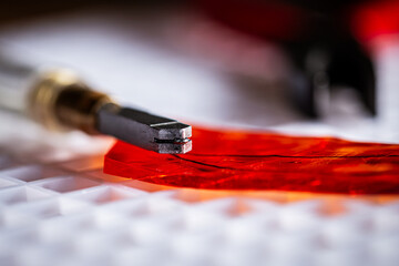 cutting and breaking red glass with a glass cutter