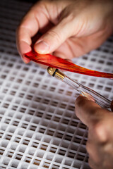 cutting and breaking red glass with a glass cutter
