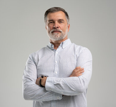 portrait of confident businessman. Entrepreneur in blue shirt, mature age man standing, isolated on white background
