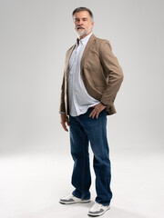 Entrepreneur in jacket smiling, Happy mid adult, mature age man standing, smiling, isolated on white background