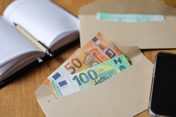 Personal and family finances. Money counting and saving. Woman distributes and saves money. Tracking expenses and saving mobey for future. Finance planning. 