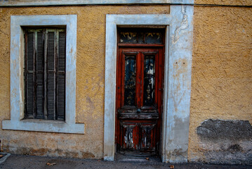 Fototapeta premium Weathered wooden door and shuttered window