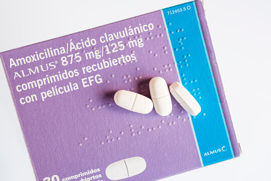 Three tablets on a box of amoxicillin antibiotics.