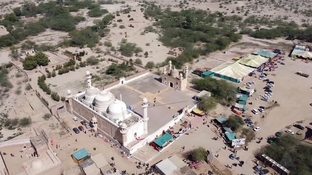 Majestic white marble abbasi mosque in cholistan desert - aerial drone shot of islamic architecture pakistan