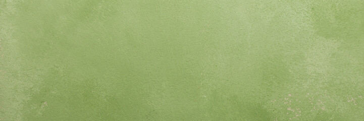 Fototapeta premium A light green surface is visible with different textures and small spots. It has an irregular pattern, and could work as a solid background, banner
