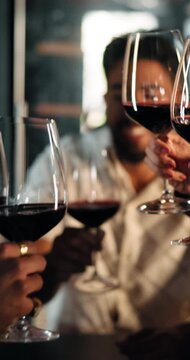 Friends, hands and wine glasses with cheers for social event or get together in restaurant. Happy group, people or gala with alcohol or toast in celebration for friendship, evening out or dining