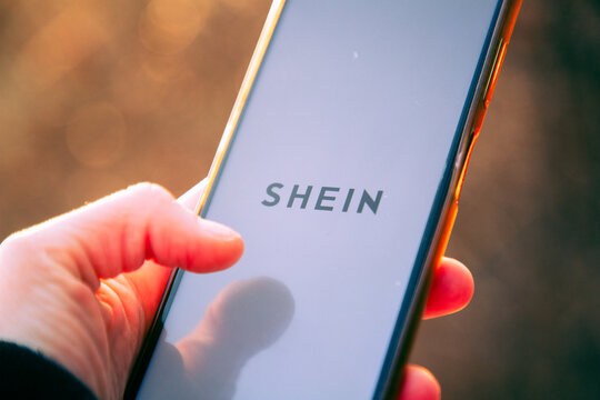 person opening shein app on a phone