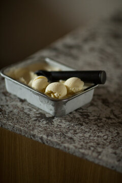 Scoops of homemade lemon ice cream on a stone  table