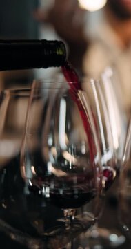 Pour, wine and serving alcohol with pub, night or bartender with bottle for order, glass or liquid. Preparing, drink and person with liquor for social event, hospitality and server with beverage