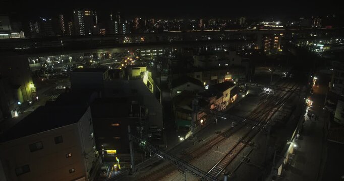 Glowing, silhouetted Japanese city at night - high shot
