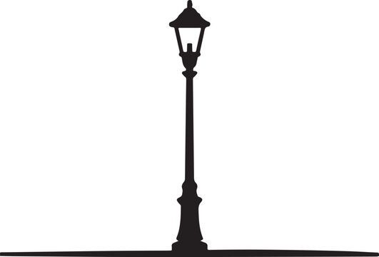 A tall elegant classic lamppost silhouette stands upright providing old fashioned street lighting