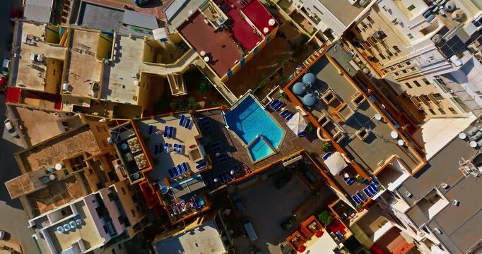 Aerial view of tourist apartments with a swimming pool on the island of Malta. The housing market and construction of tourist housing on the island.